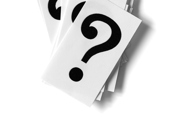 Stack of cards with large black question marks on a white background