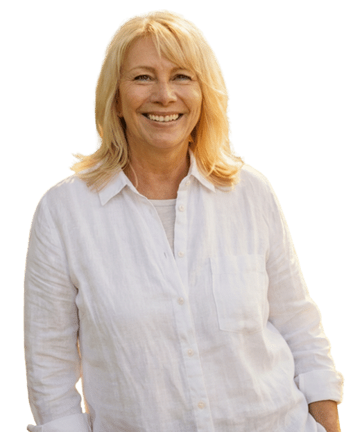 Smiling blonde woman in a white shirt against a plain background